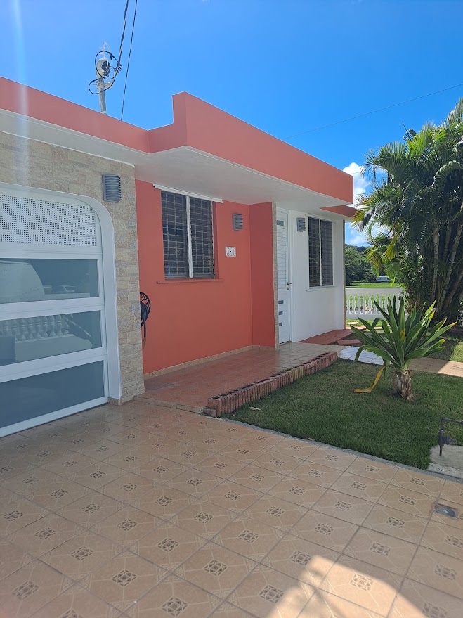 Casa Chunan front entrance with palm landscaping and blue sky